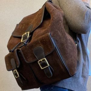 Coach Suede Leather Backpack with heavy rawhide leather and brass buckles.